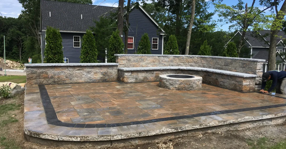 Residential landscaping project in Belmont, MA with retaining wall and plantings