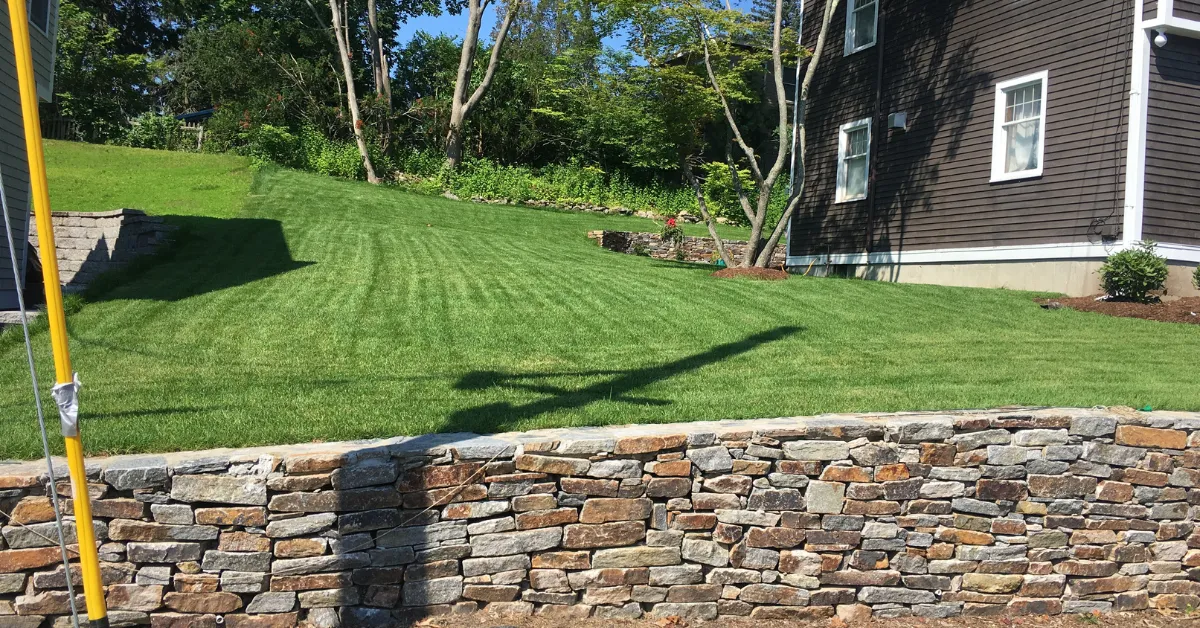 Custom patio with stone walkway in Boxford, MA, backyard